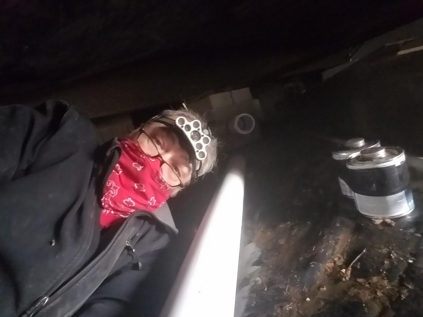 Another busted main sewer line under a house. The bandana didn\'t help with the smell!