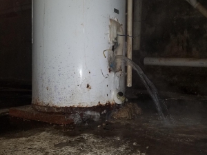This looks like a bad leak but it's not. We re-build water heaters. We replace both thermostats and elements AND vacuum out the lime. This water heater was in a basement and the floor drain was right next to it. So we pulled the bottom element and the water went right down the drain. We had the water heater re-build and the water turned back on within 30 minutes. 