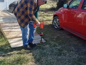 This is Randy locating a sewer line underground. We have the ability to run a camera down a sewer line to see inside the pipes. The camera head also sends out a signal that can be picked up by the wand he is holding. We know exactly where and how deep the pipe is.